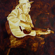 Angel Sarkela-Saur created this original "Vintage Val" Coffee Art® painting. It features an old cowboy strumming an old tune on his guitar.